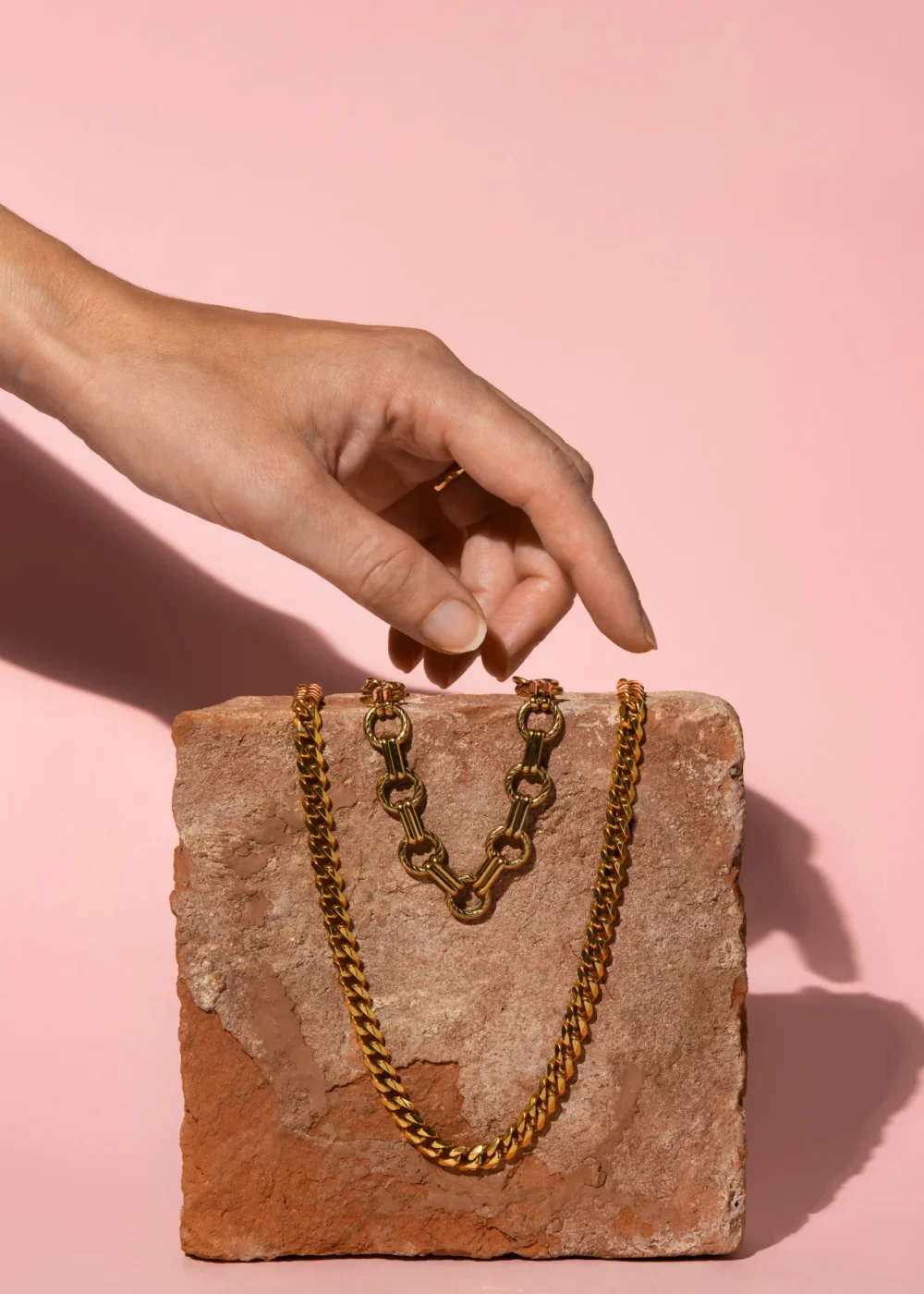 hand touching gold chains 11zon 11zon